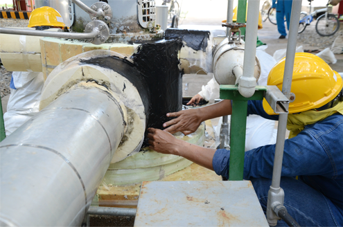 workers make repairs due to an industrial insulation problem